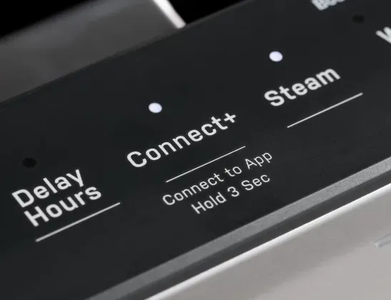 Close-up of dishwasher controls showing Delay Hours, Connect+ Wi-Fi, and Steam pre-wash settings.